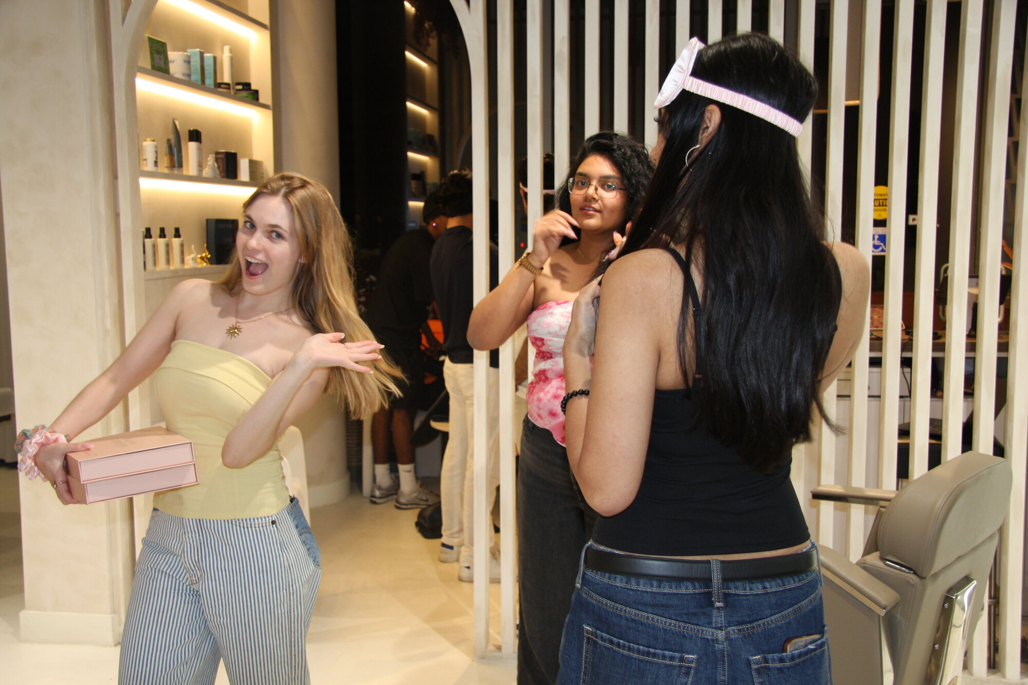 A producer coordinating on set during a shoot, crew and lighting behind her.