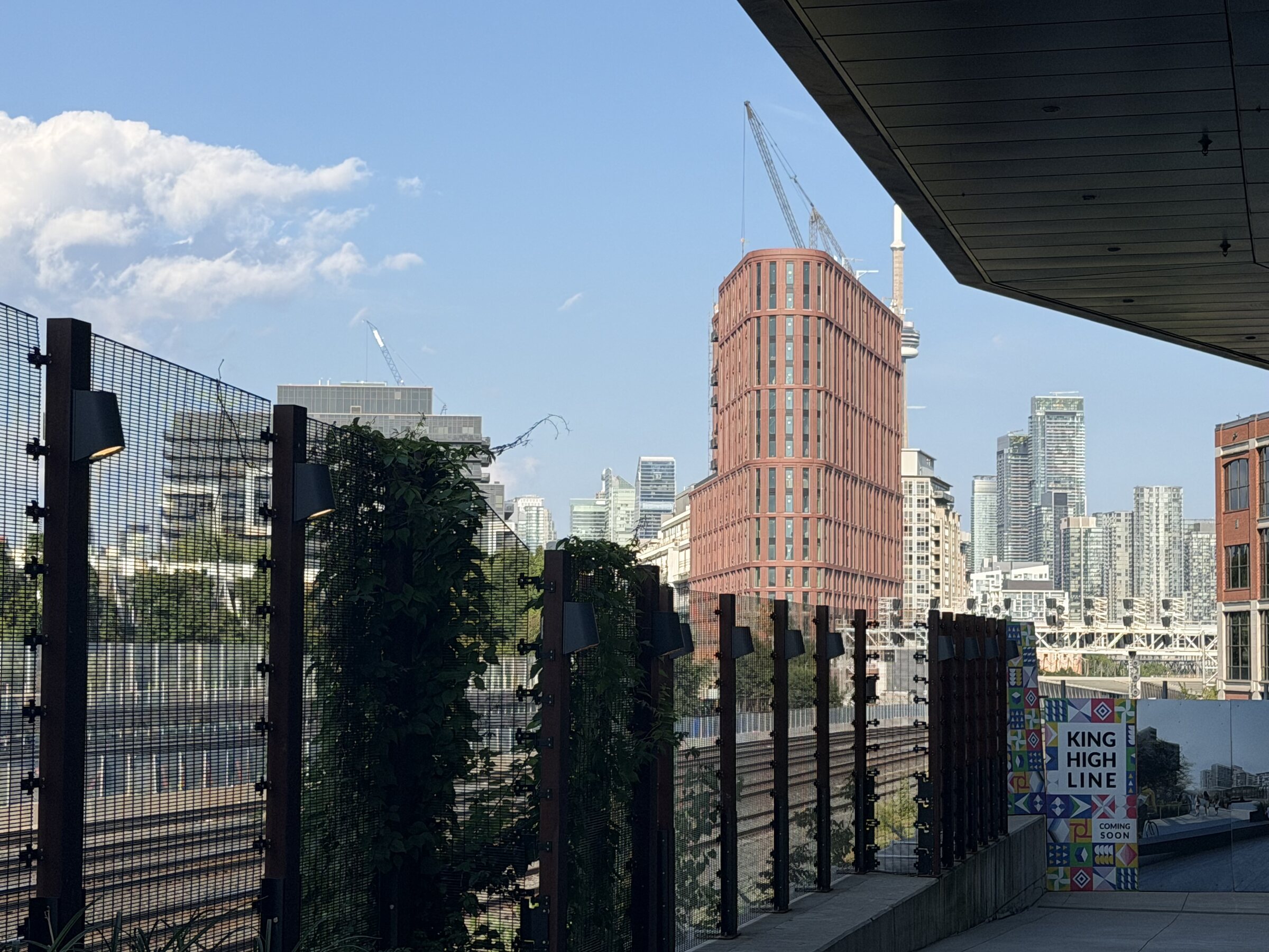 Toronto seen from outside TNAADO's King Street West office: the King High Line, rail corridor and the downtown skyline with the CN Tower.